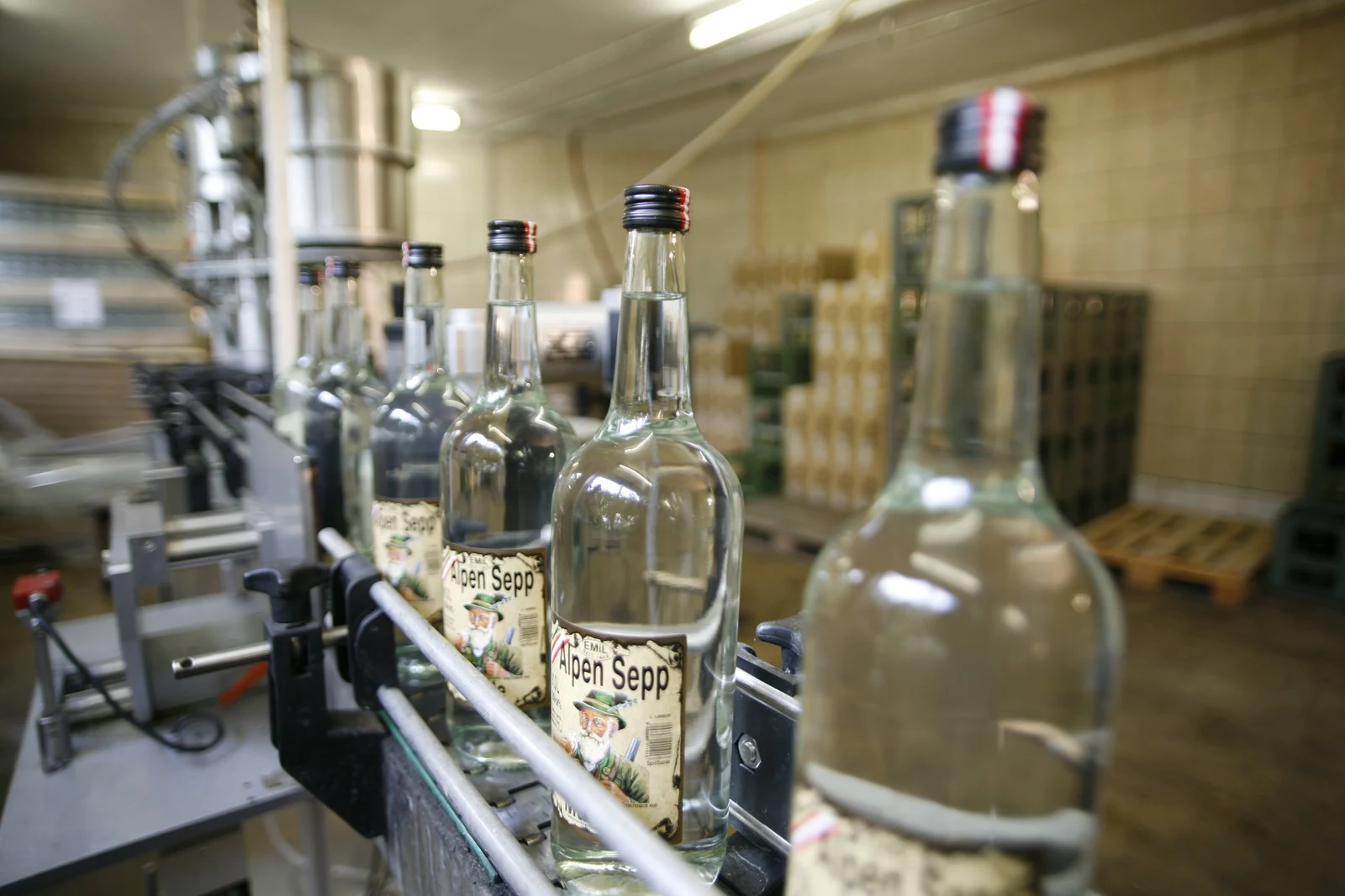 Bottles with historical Alpen Sepp labels on the bottling line.