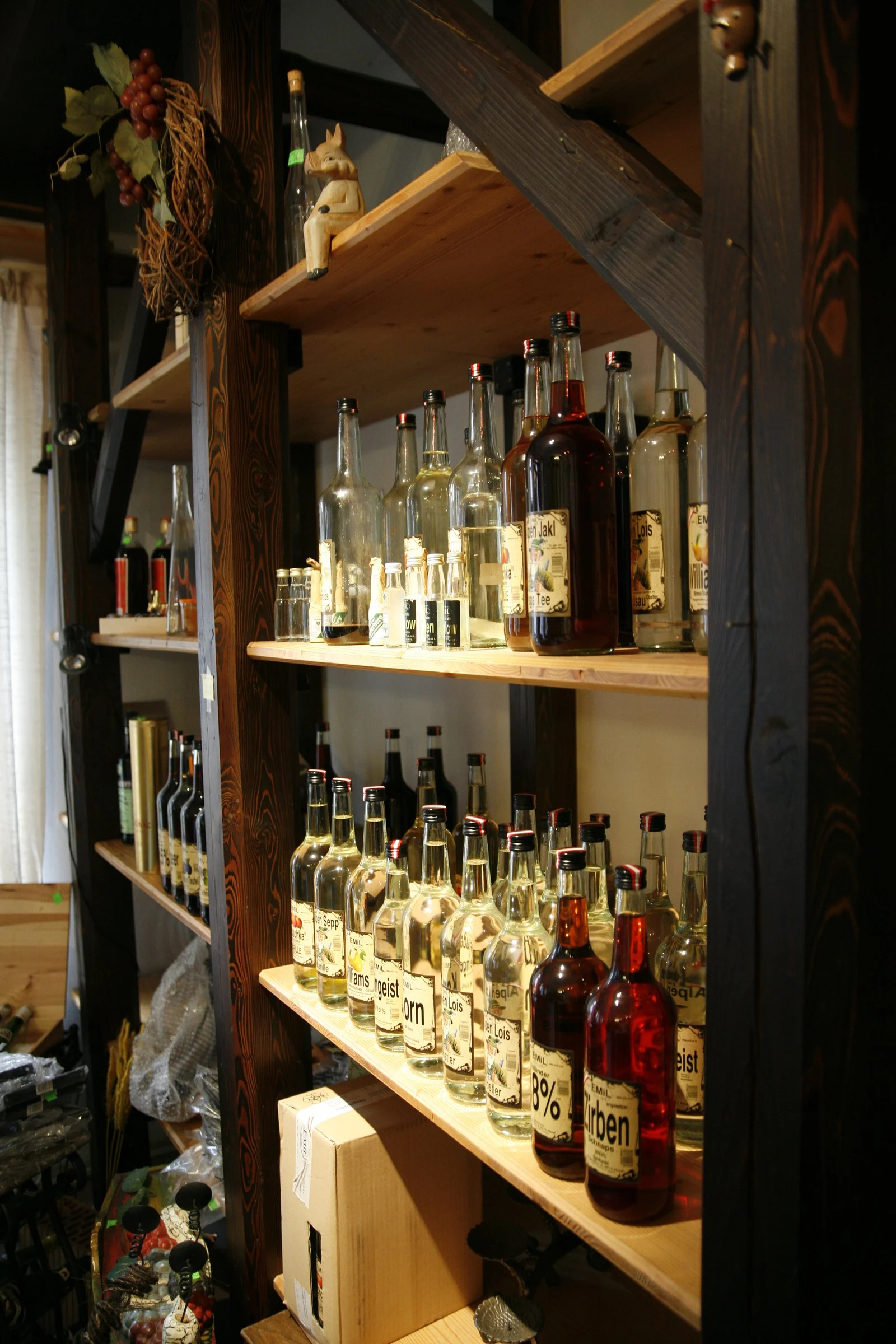 Historical spirit bottles on wooden shelving.